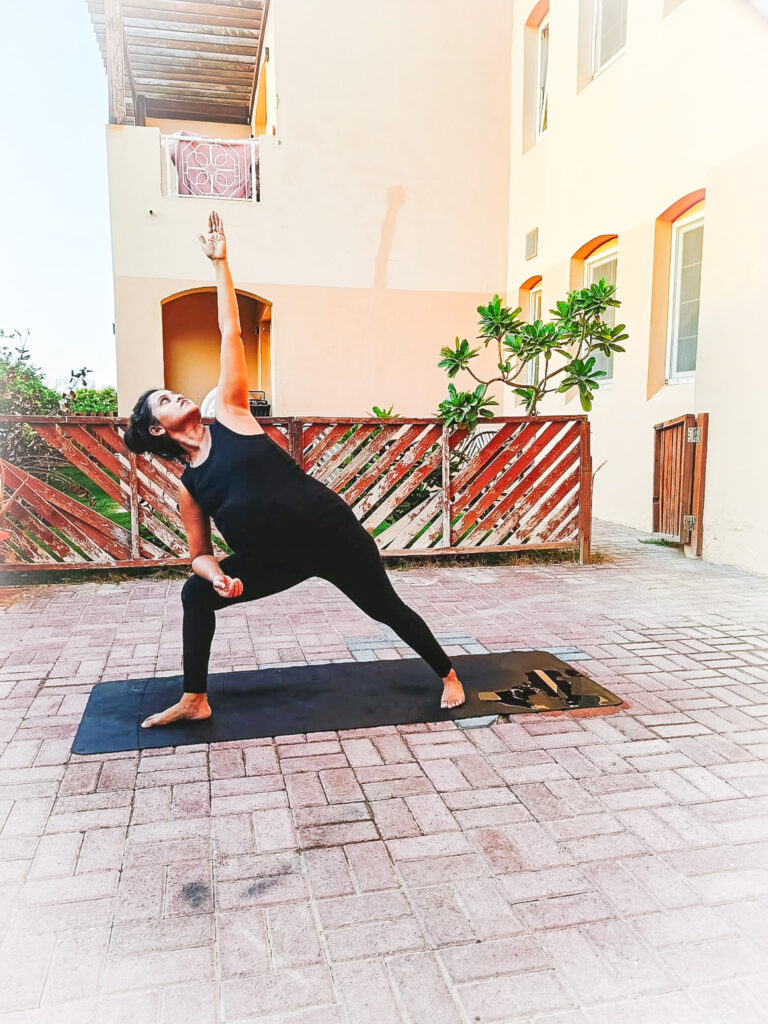 Image of a Pregnant lady practicing Extended Side Angle Pose