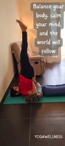 IMAGE OF A LADY PRACTICING SHOULDER STAND WITH TWO BOLSTER